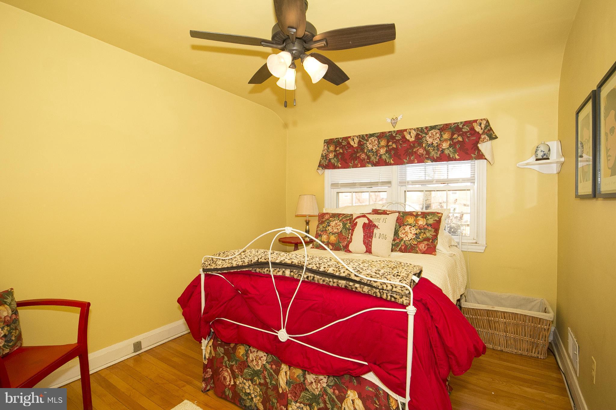 8616 Black Oak Road Baltimore, MD 21234 - Photo 15 of 21 a bed sitting in a bedroom next to a window