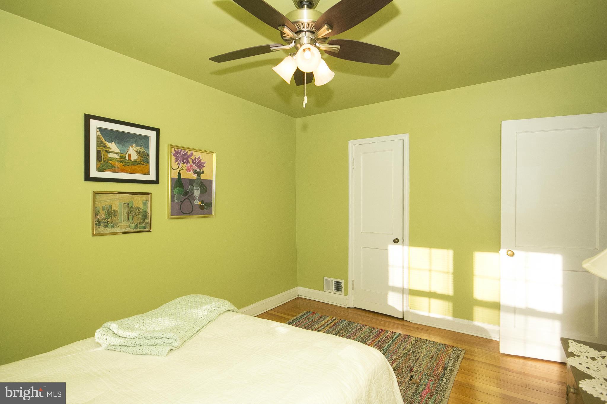 8616 Black Oak Road Baltimore, MD 21234 - Photo 18 of 21 a bedroom with a bed and a chandelier