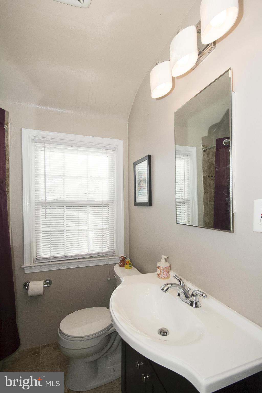 8616 Black Oak Road Baltimore, MD 21234 - Photo 19 of 21 a bathroom with a sink a mirror and a toilet