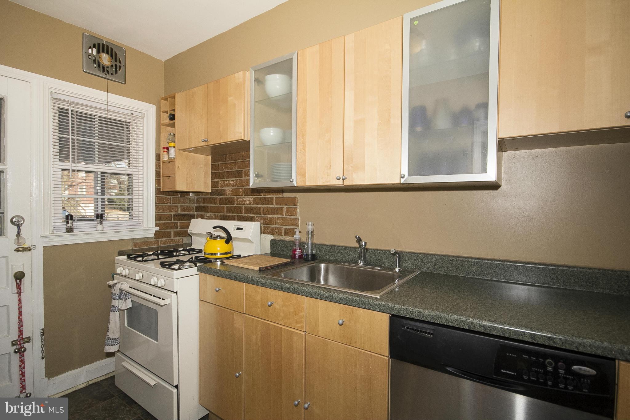 8616 Black Oak Road Baltimore, MD 21234 - Photo 7 of 21 a kitchen with stainless steel appliances a sink a stove and a window