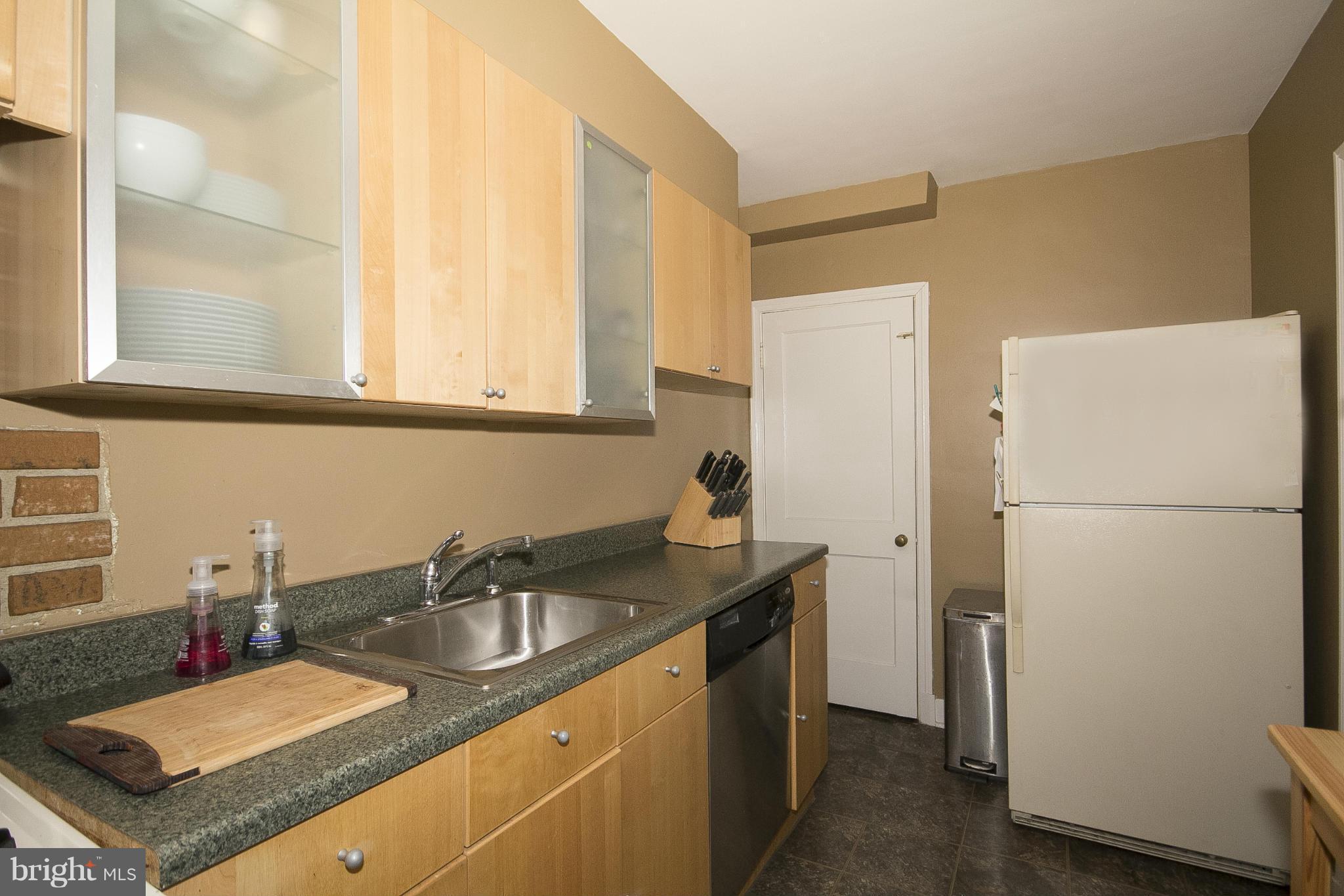 8616 Black Oak Road Baltimore, MD 21234 - Photo 8 of 21 a kitchen with sink refrigerator and cabinets