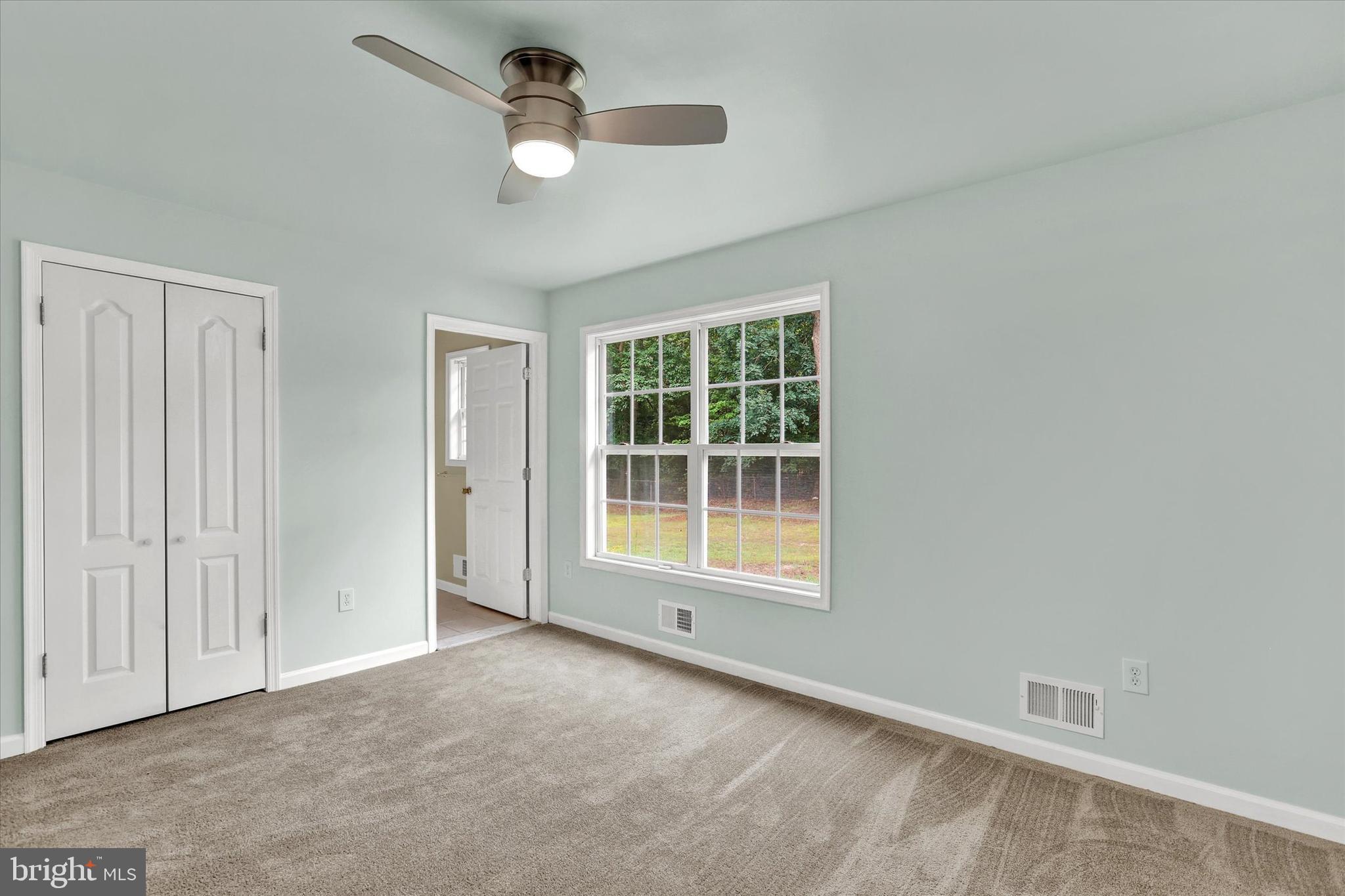77 Hockamick Road Cookstown, NJ 08511 - Photo 13 of 25 an empty room with ceiling fan and window
