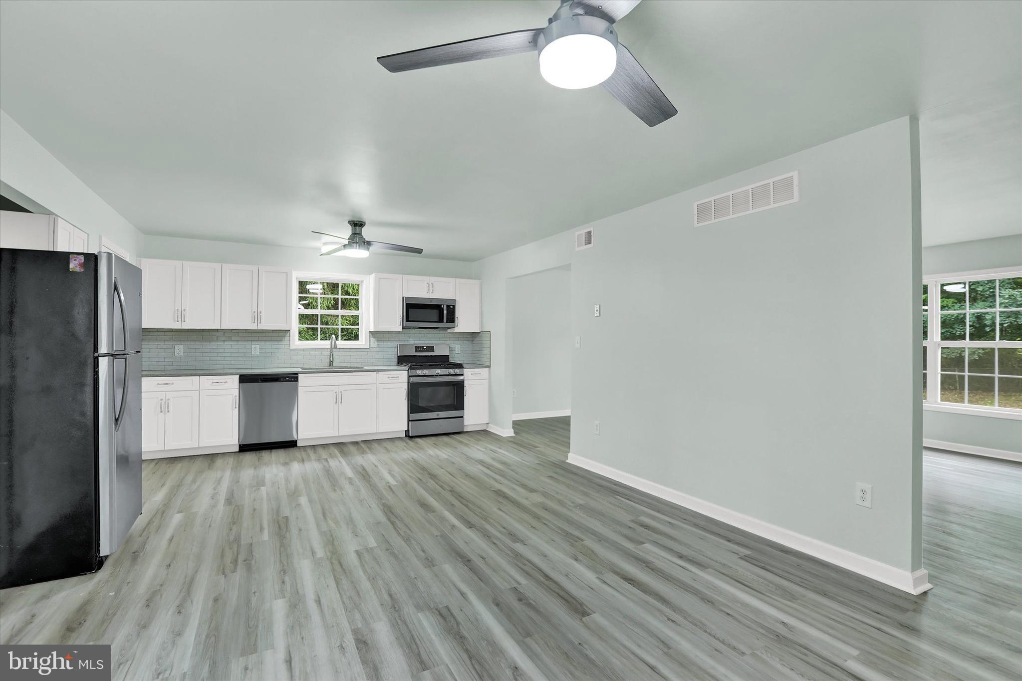 77 Hockamick Road Cookstown, NJ 08511 - Photo 4 of 25 a large kitchen with cabinets wooden floor and stainless steel appliances
