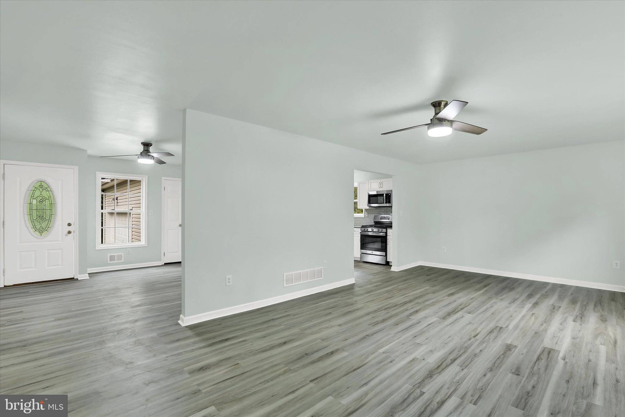 77 Hockamick Road Cookstown, NJ 08511 - Photo 9 of 25 an empty room with wooden floor chandelier and windows