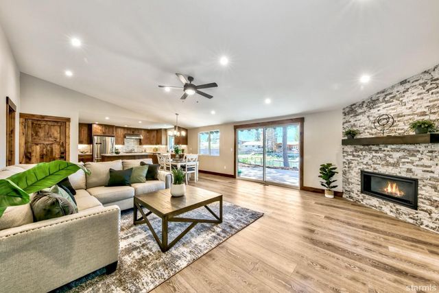 a living room with furniture fireplace and window