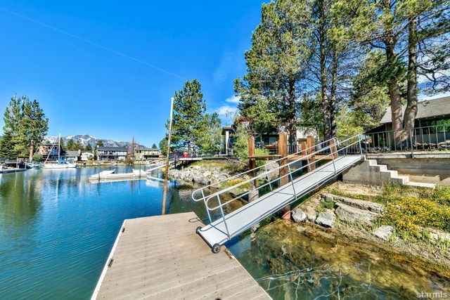 a view of swimming pool with outdoor seating and lake view
