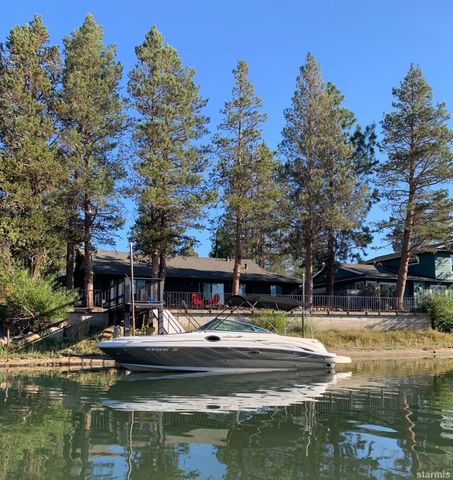 a view of a lake with boats and trees in the background