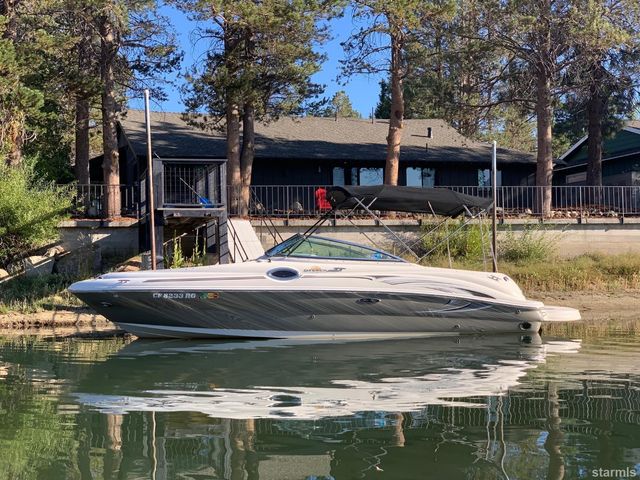 a view of house with pool and chairs