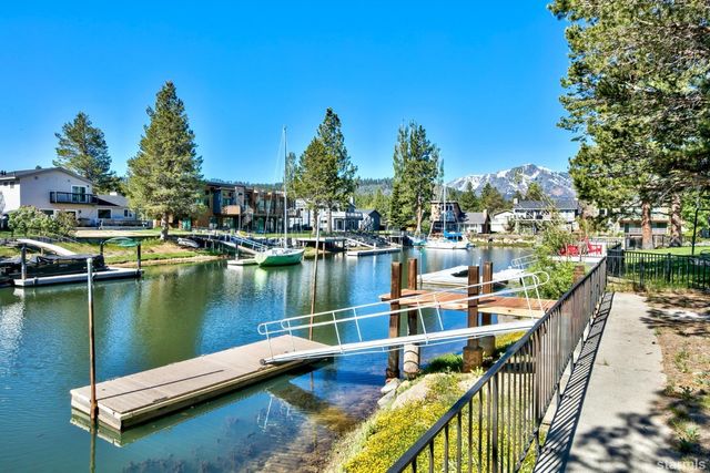 a view of a lake with boats and trees in the background