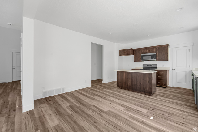291 North Slant Road, Unit 46M Mapleton, UT 84660 - Photo 19 of 19 Kitchen with stainless steel appliances, a center island, dark wood finish cabinets, light wood-style floors, and open floor plan