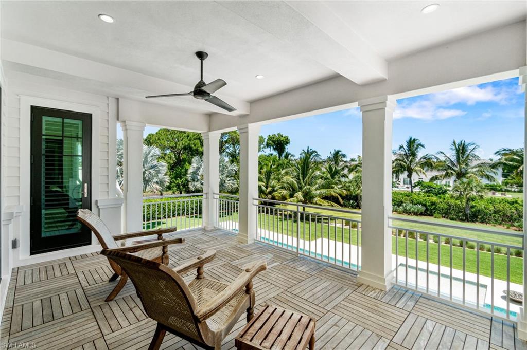 171 North Street Naples, FL 34108 - Photo 21 of 50 Empty room featuring a tray ceiling, hardwood / wood-style floors, and ceiling fan