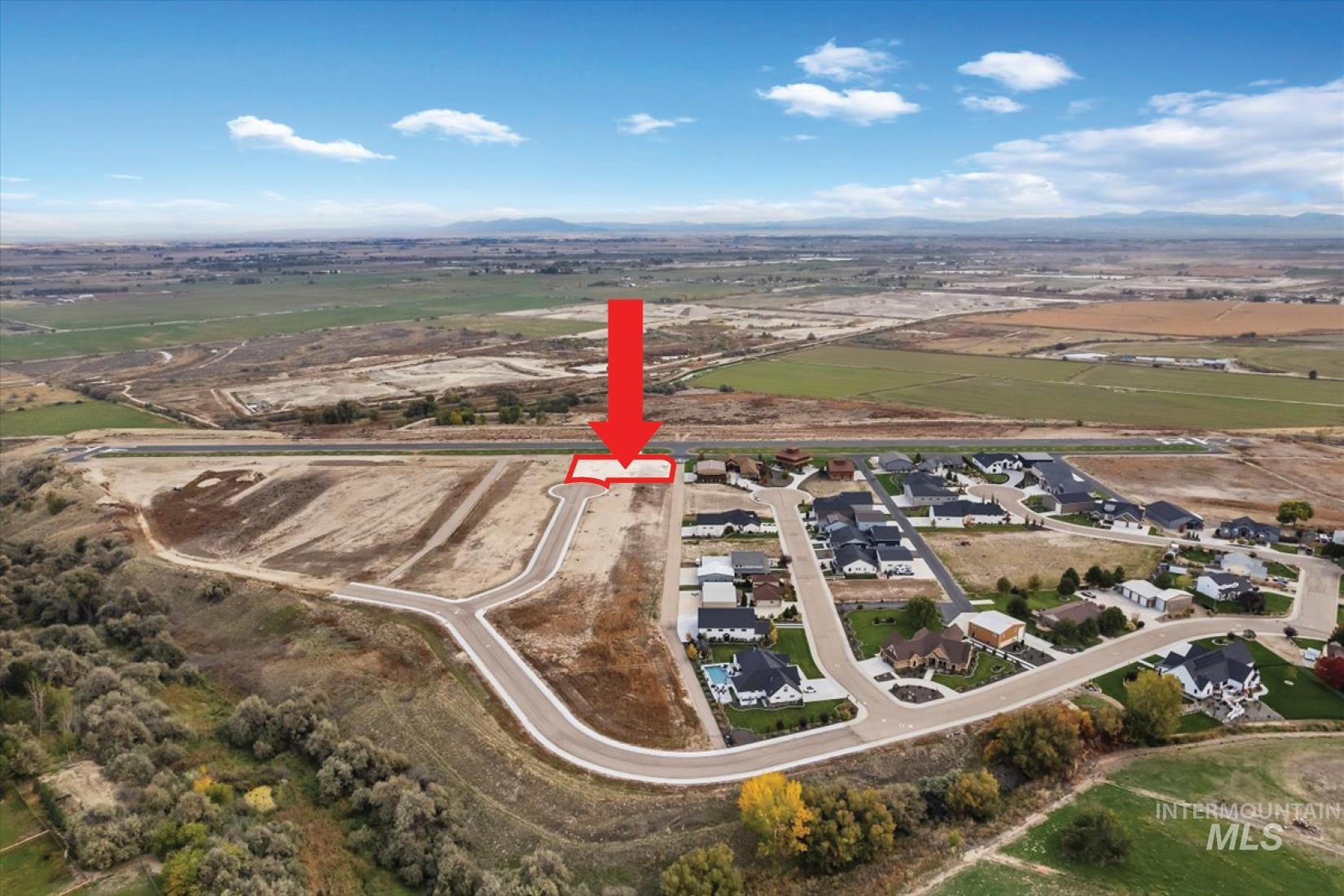 View of property location featuring nearby suburban area and rural landscape