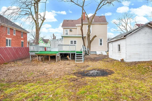 a backyard of a house with table and chairs