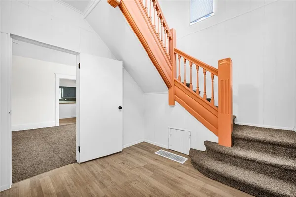 a view of entryway and hall with wooden floor