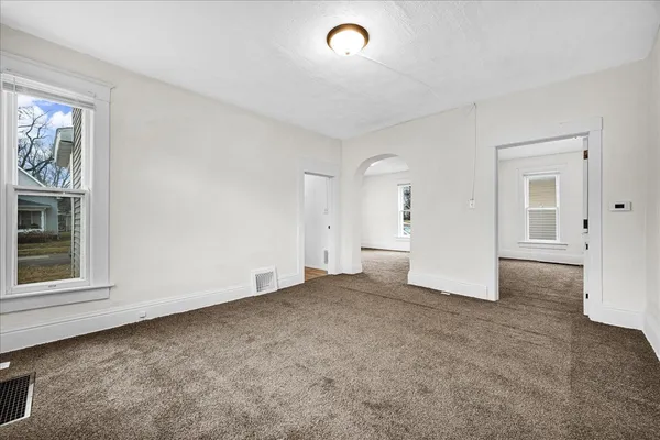an empty room with windows and closet