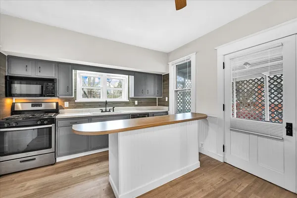 a kitchen with stainless steel appliances granite countertop a stove and a sink