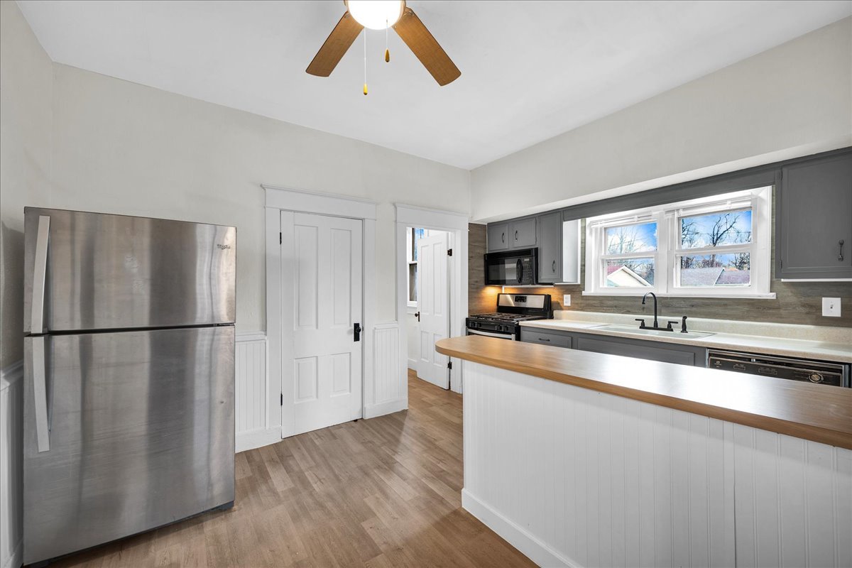 449 North 3rd Avenue Canton, IL 61520 - Photo 7 of 28 a kitchen with stainless steel appliances a refrigerator a sink a stove and cabinets