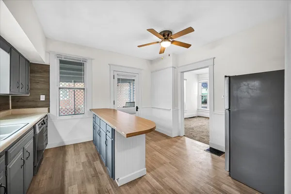 a kitchen with a refrigerator and a sink