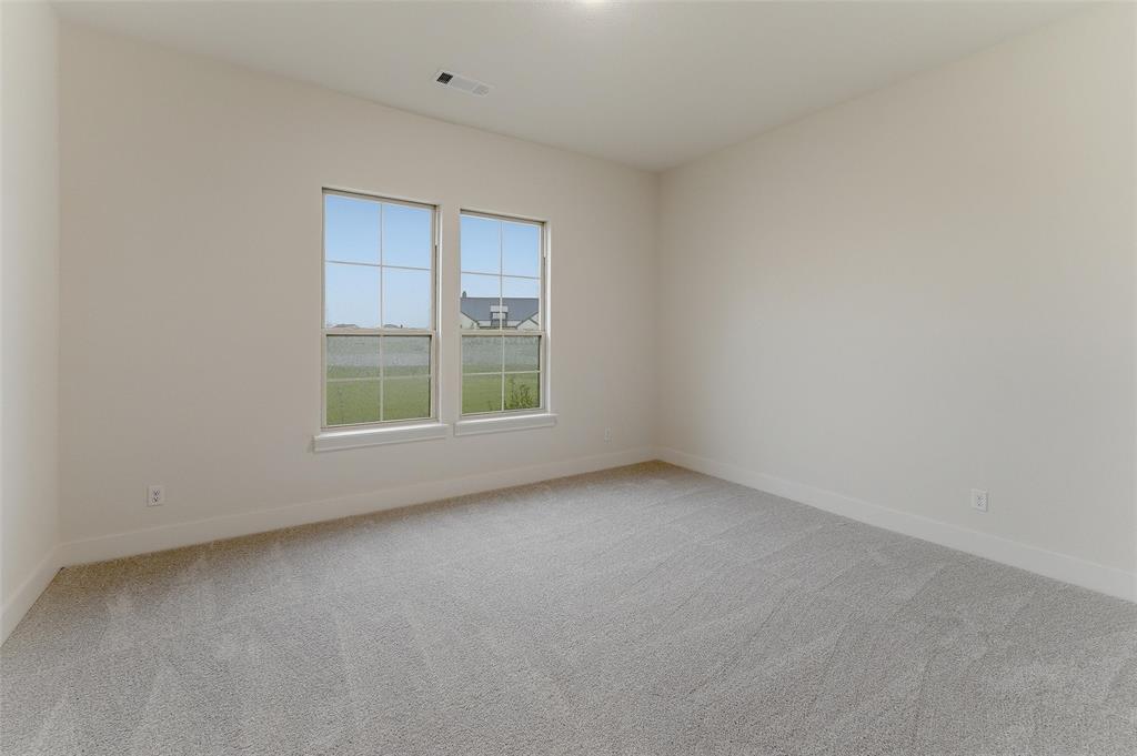 2208 Continent Court Krum, TX 76249 - Photo 7 of 26 Room featuring two large windows with white trim, light gray carpet, white baseboards, and light neutral walls