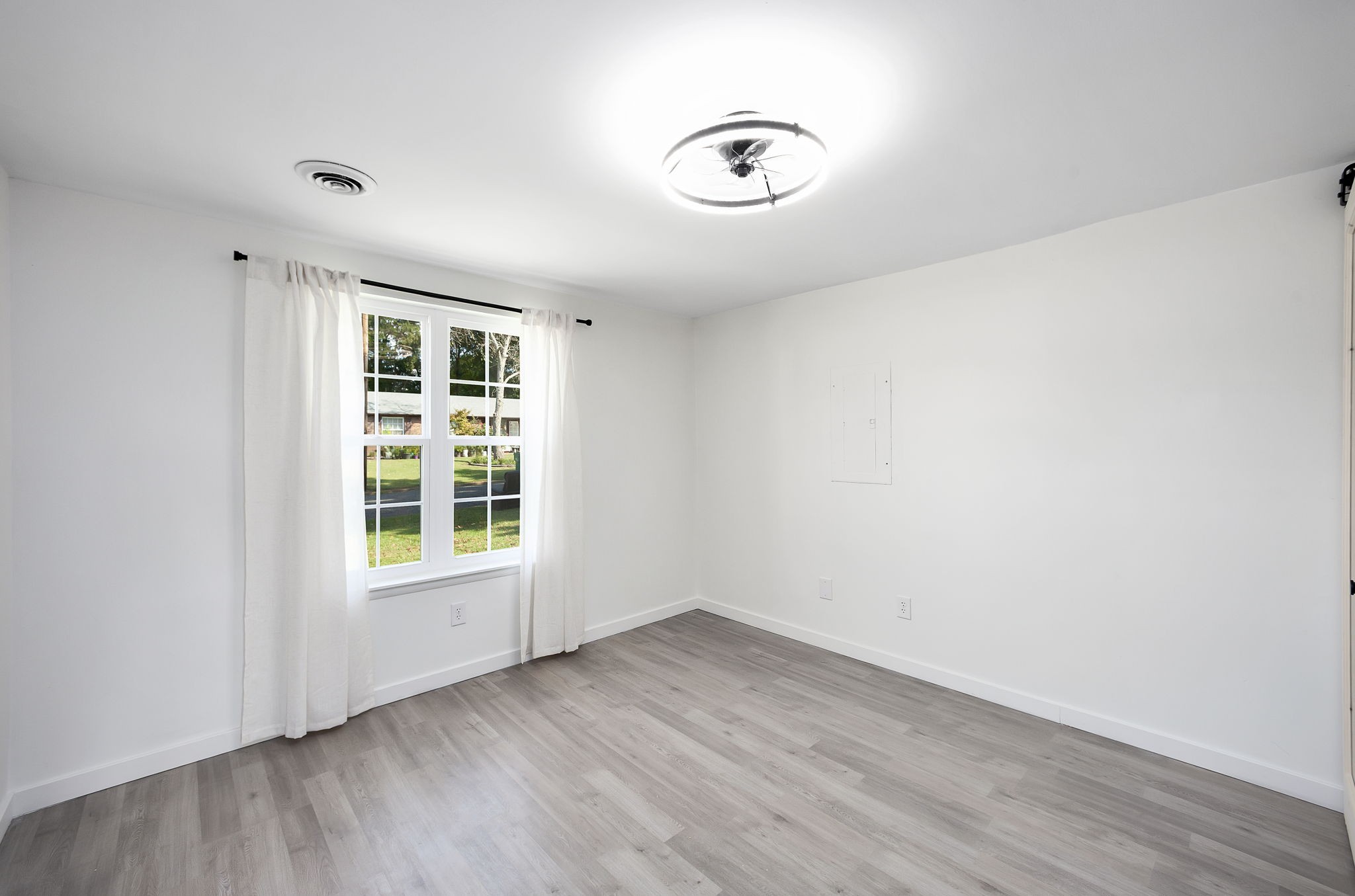 5 Raintree Cove Jackson, TN 38305 - Photo 13 of 25 an empty room with wooden floor and windows
