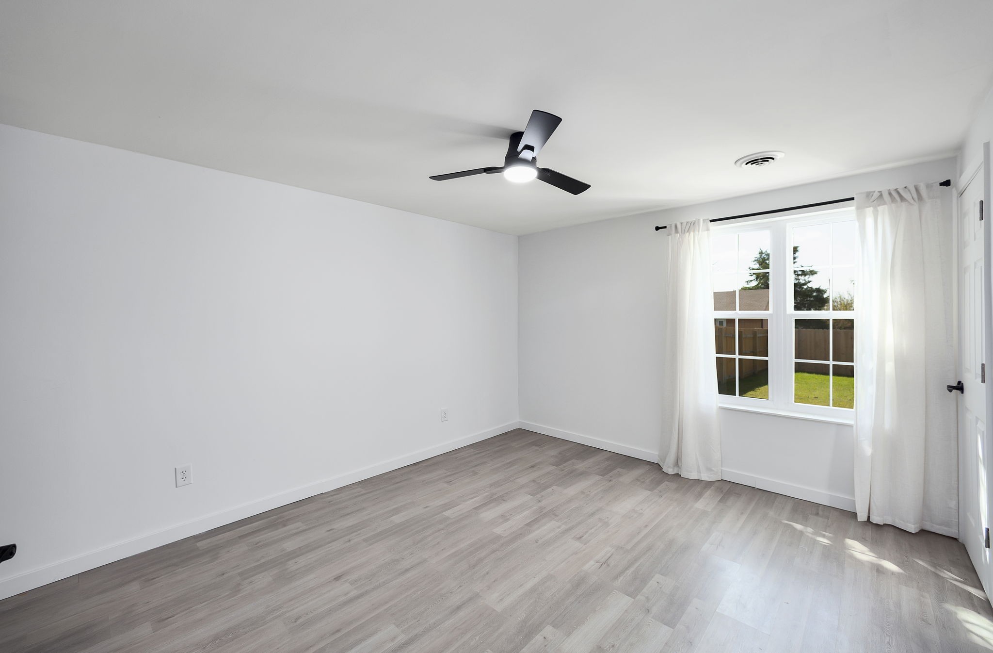 5 Raintree Cove Jackson, TN 38305 - Photo 16 of 25 a view of empty room with wooden floor and fan