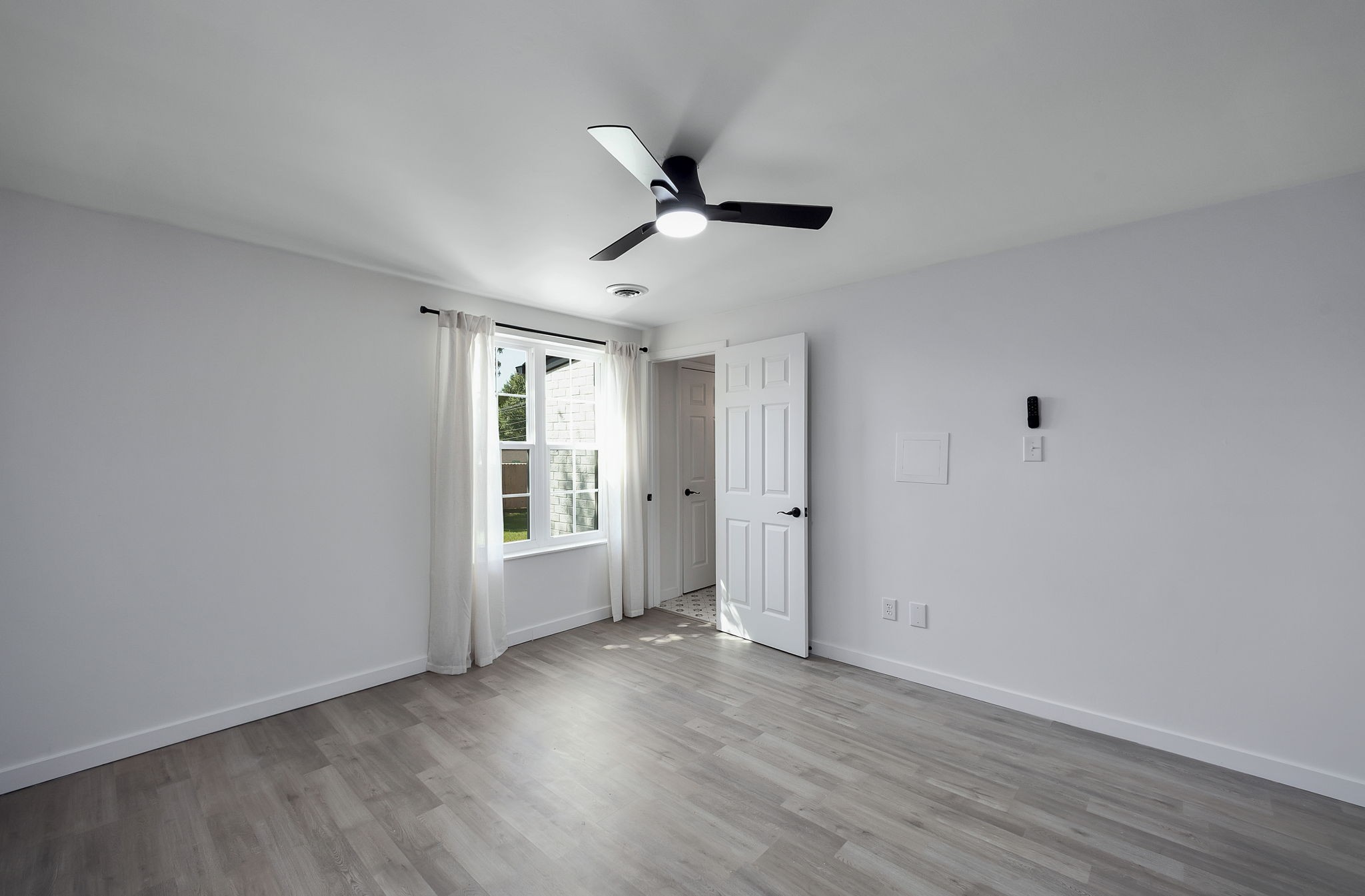 5 Raintree Cove Jackson, TN 38305 - Photo 17 of 25 a view of an empty room with wooden floor and a window