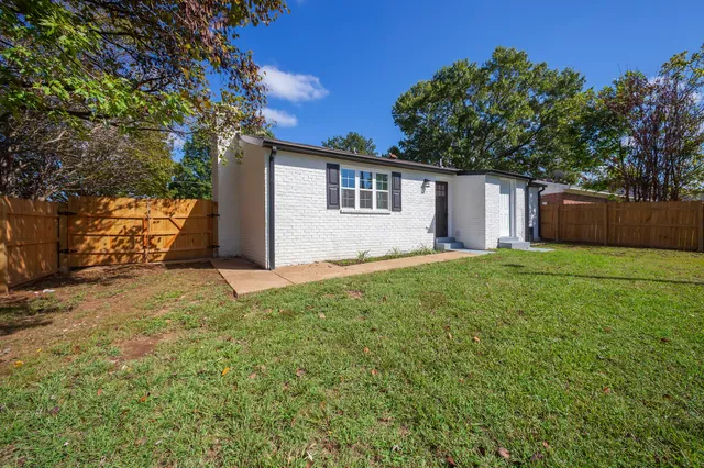 a backyard of a house with large trees
