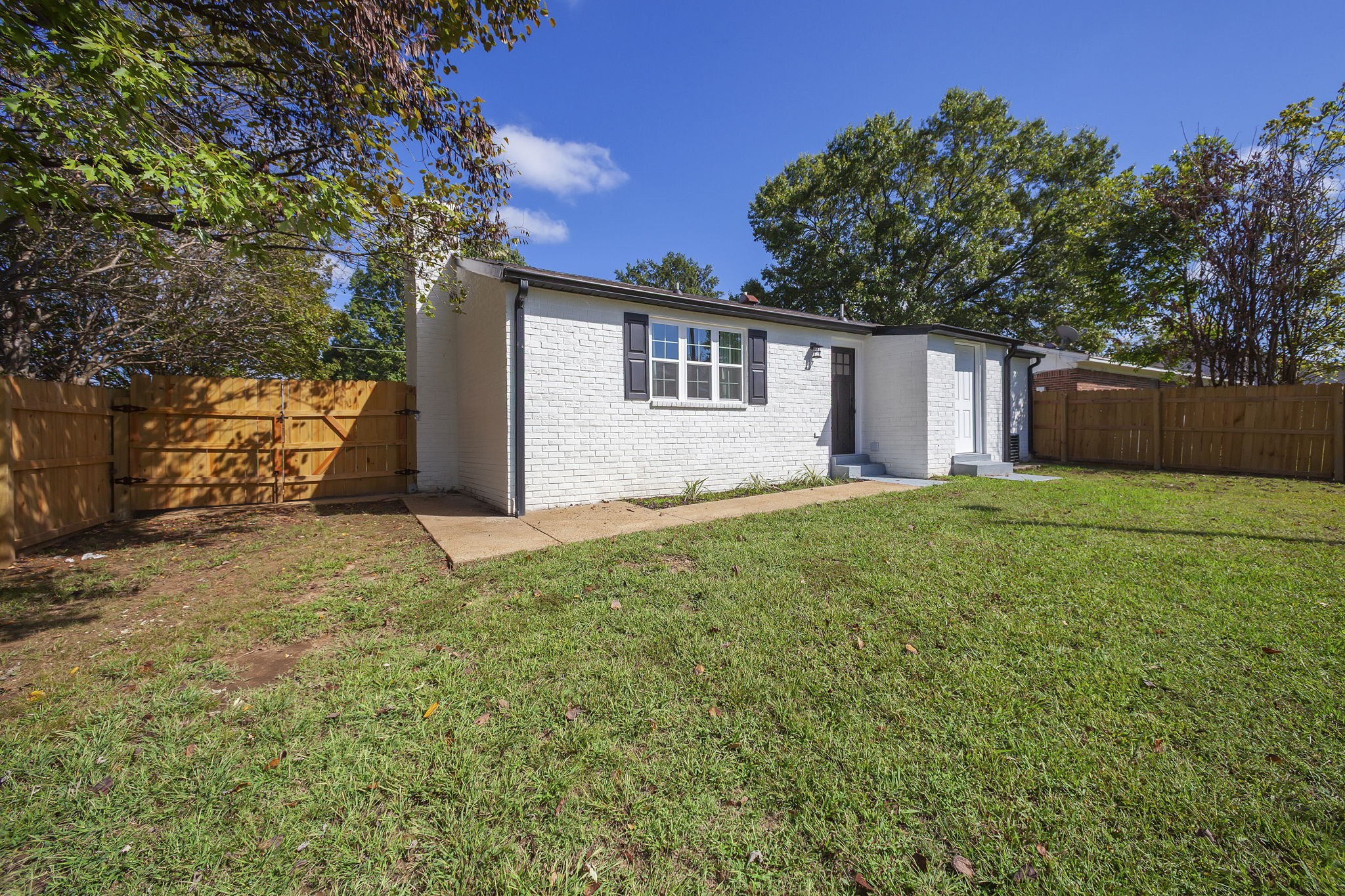 5 Raintree Cove Jackson, TN 38305 - Photo 21 of 25 a backyard of a house with large trees