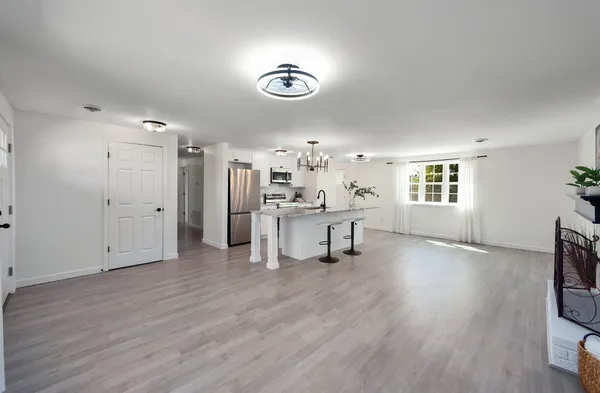 a view of a livingroom with a furniture wooden floor and windows
