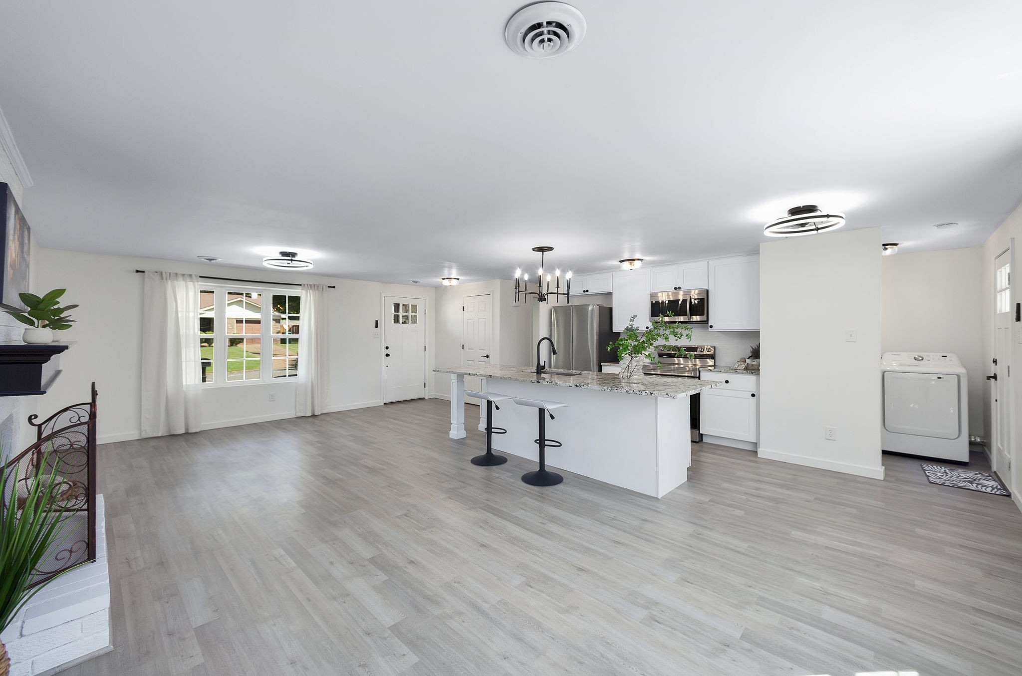 5 Raintree Cove Jackson, TN 38305 - Photo 6 of 25 a kitchen with stainless steel appliances kitchen island wooden floors and white cabinets