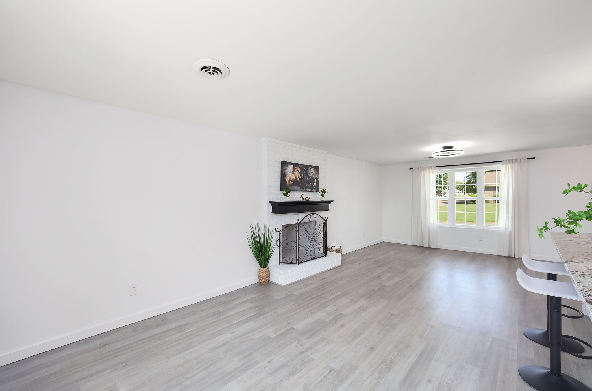 5 Raintree Cove Jackson, TN 38305 - Photo 7 of 25 an empty room with wooden floor and windows