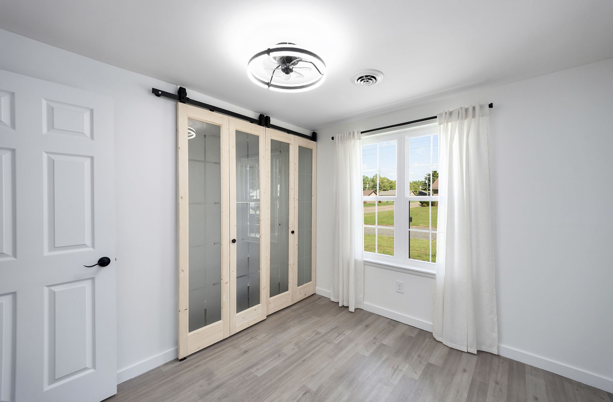 5 Raintree Cove Jackson, TN 38305 - Photo 10 of 25 a view of an empty room with wooden floor and a window
