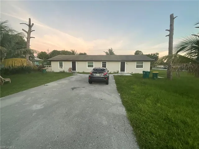 a view of a house with a backyard and a patio