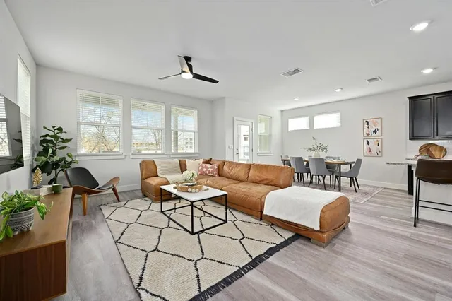 a living room with furniture a table and a potted plant