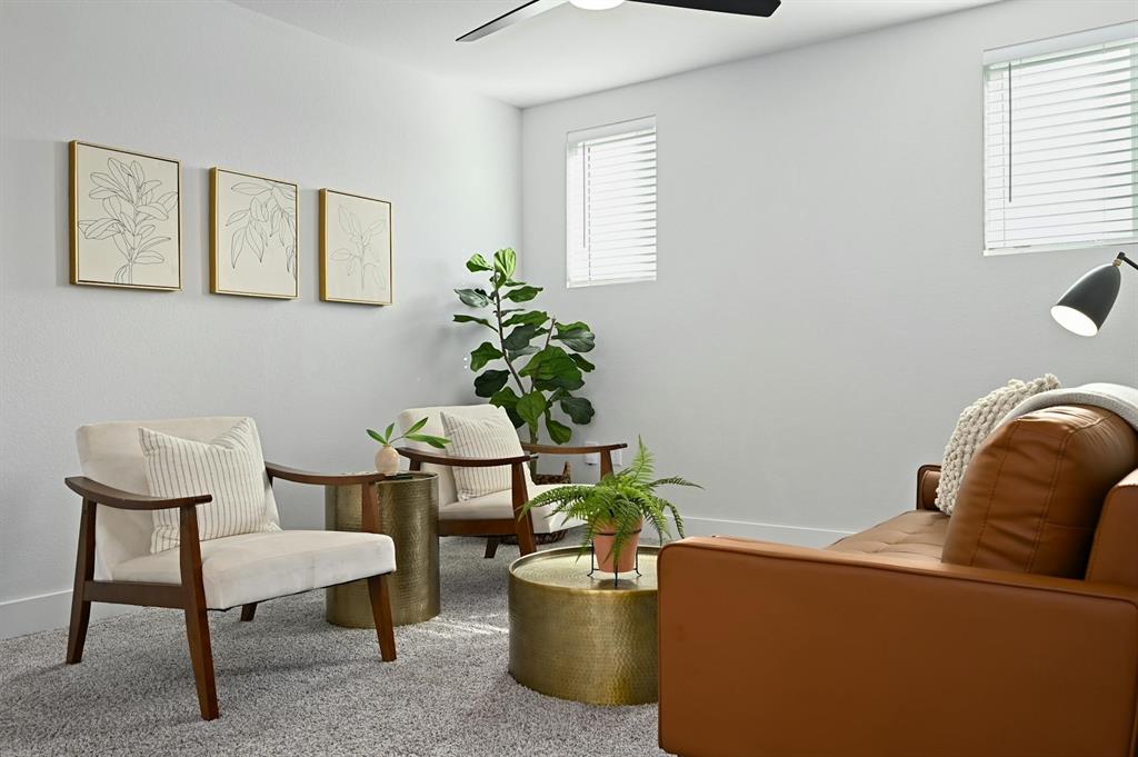 7318 Harmony Shoals Bend, Unit 182 Austin, TX 78744 - Photo 15 of 27 a living room with furniture and a potted plant