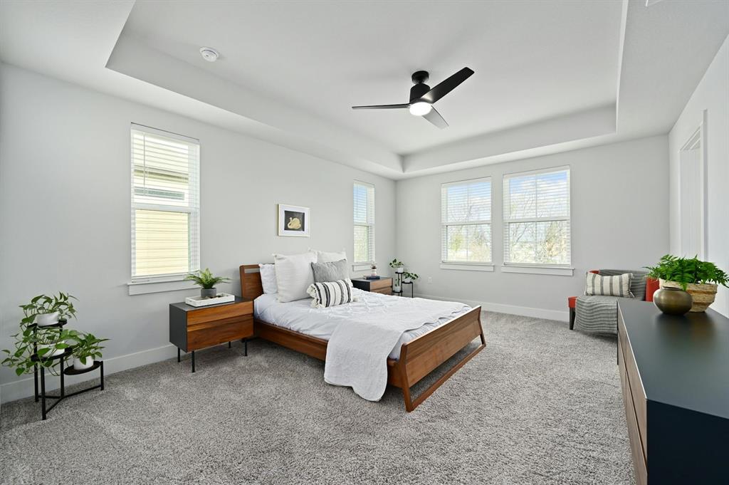 7318 Harmony Shoals Bend, Unit 182 Austin, TX 78744 - Photo 16 of 27 a spacious bedroom with a bed and windows