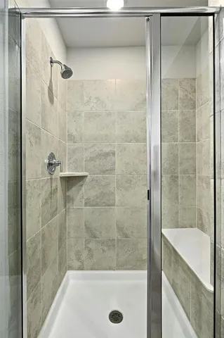 a bathroom with a shower and bathtub