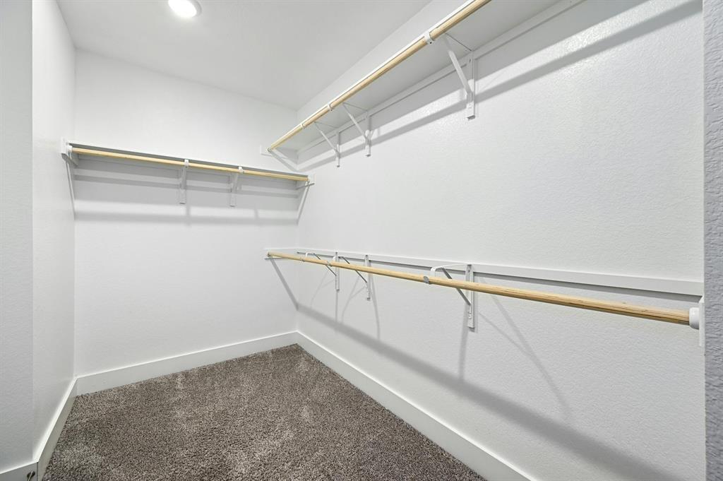 7318 Harmony Shoals Bend, Unit 182 Austin, TX 78744 - Photo 19 of 27 a view of a room with racks on the wall