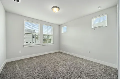 an empty room with windows and closet