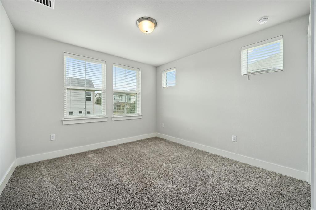 7318 Harmony Shoals Bend, Unit 182 Austin, TX 78744 - Photo 20 of 27 an empty room with windows and closet