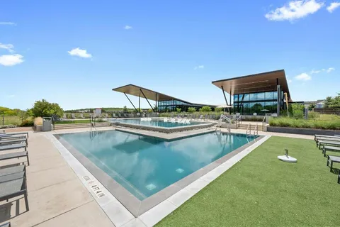 a view of a swimming pool with a table and chairs