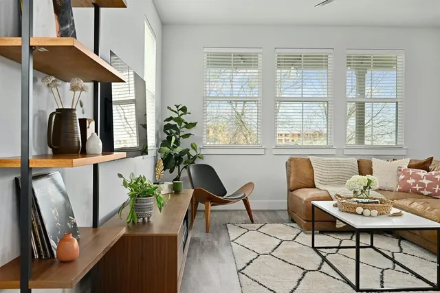 a living room with furniture fireplace and potted plants