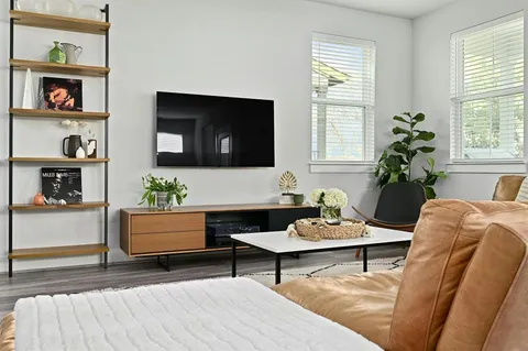 a living room with furniture and a potted plant