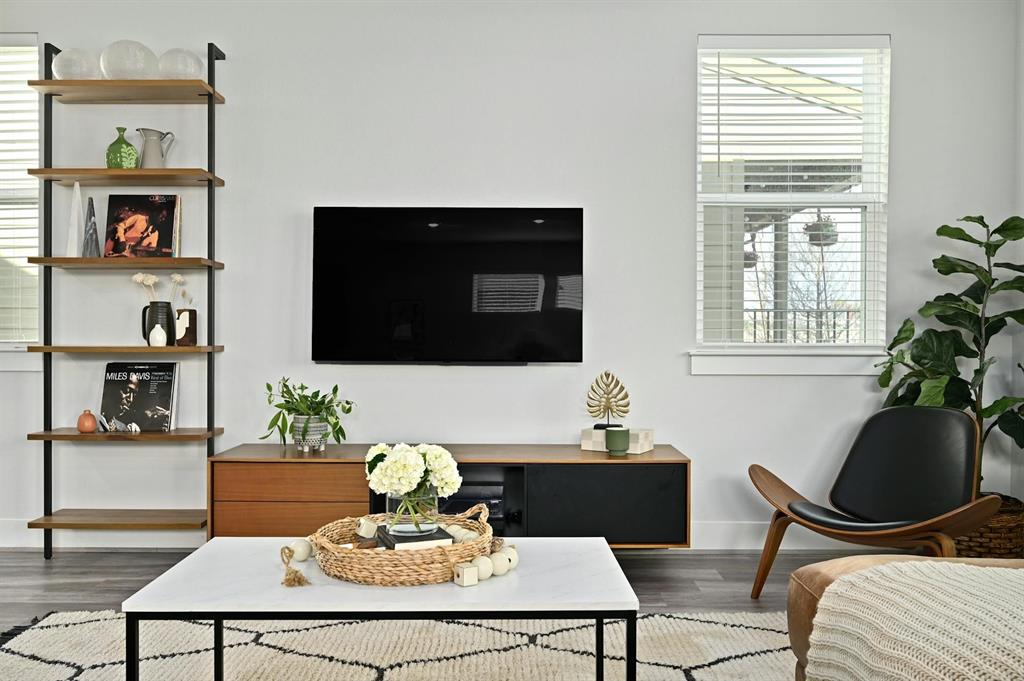 7318 Harmony Shoals Bend, Unit 182 Austin, TX 78744 - Photo 10 of 27 a living room with furniture potted plant and a window