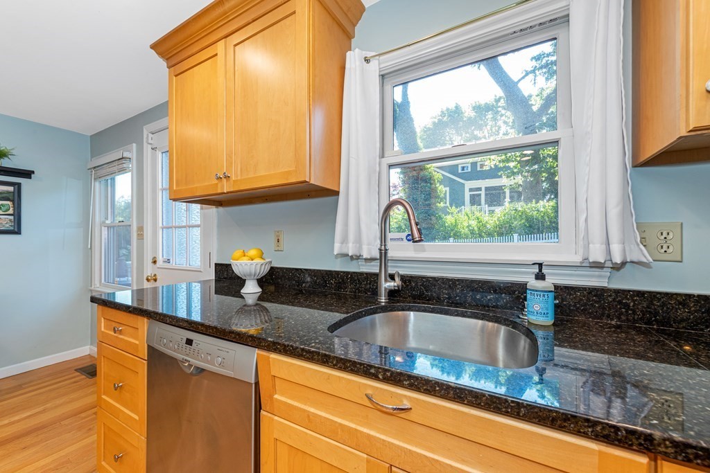 24 Fountain Road Arlington, MA 02476 - Photo 22 of 42 a kitchen with granite countertop a sink a counter and cabinets