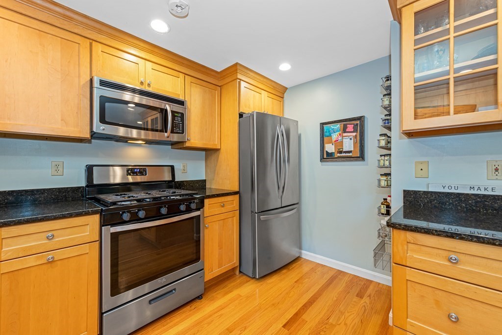 24 Fountain Road Arlington, MA 02476 - Photo 24 of 42 a kitchen with stainless steel appliances granite countertop a stove microwave and refrigerator