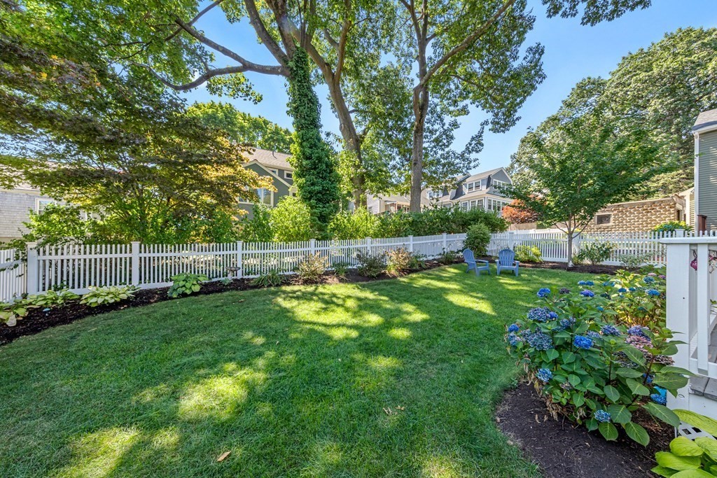 24 Fountain Road Arlington, MA 02476 - Photo 8 of 42 a view of a backyard with a bench and plants