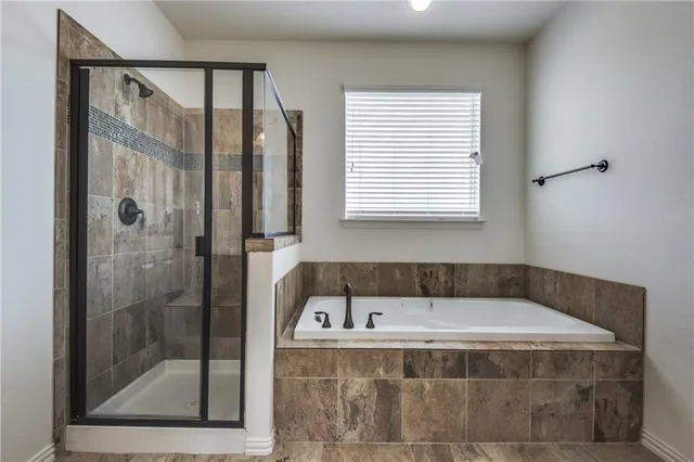 a bathroom with a bathtub and shower