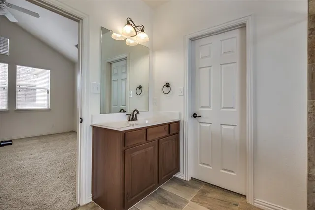 a bathroom with a sink vanity and mirror