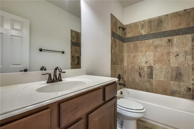 a bathroom with a sink a toilet and a bathtub